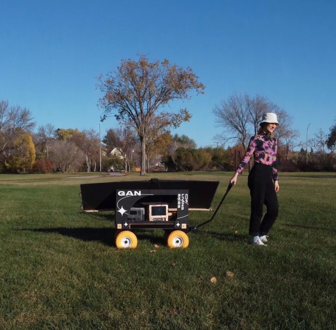 The artist activating the WaGAN cart outside Art Gallery of Regina.