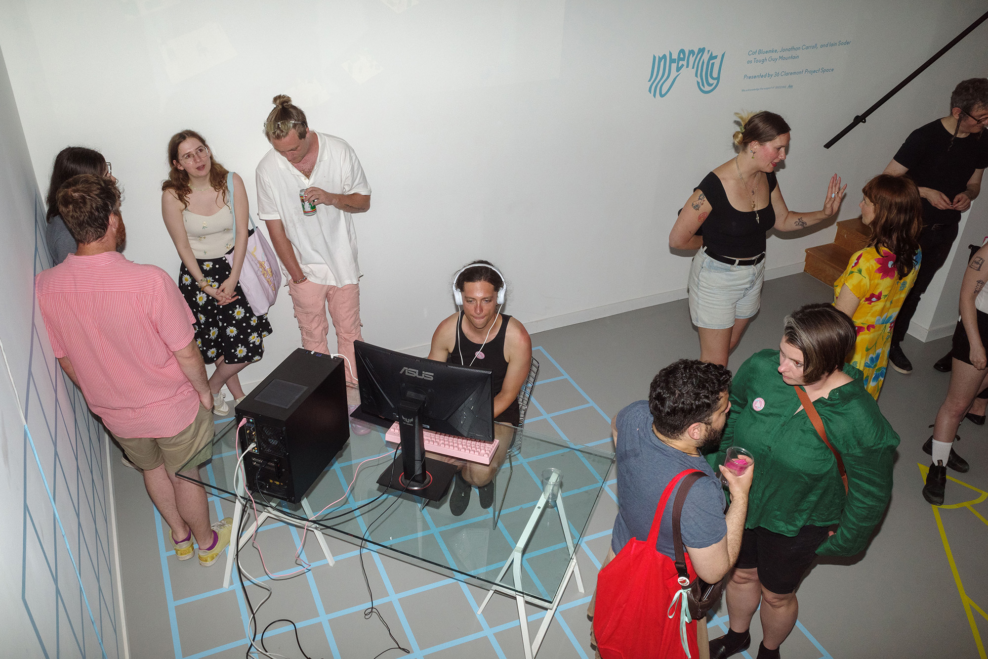 Exhibition view of Internity at Claremont Project Space, Toronto, with VR headsets and projected interface.